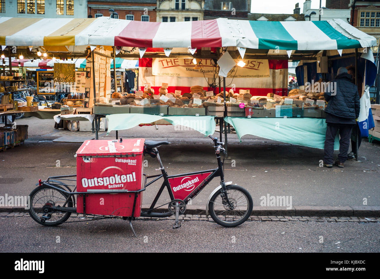 Eco Delivery - A cargo bike belonging to the Outspoken last mile delivery company parked in Cambridge Market in the historic centre of Cambridge UK. Stock Photo