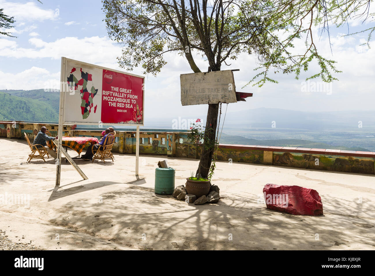 Roadside viewpoint rest stop with people sat at a table looking at the view to the Rift valley, Kenya, East Africa Stock Photo