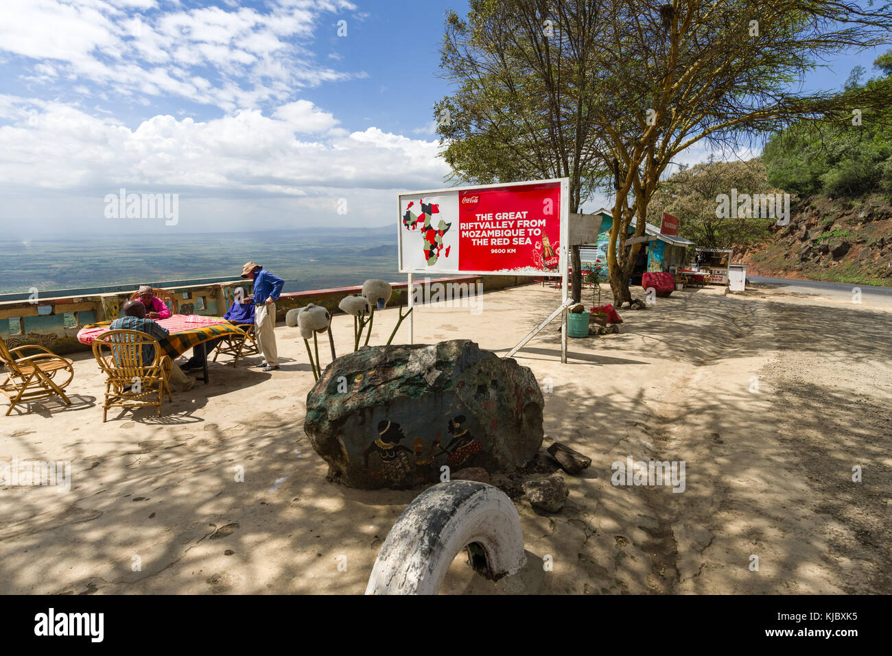 Roadside viewpoint rest stop with people sat at a table looking at the view to the Rift valley, Kenya, East Africa Stock Photo