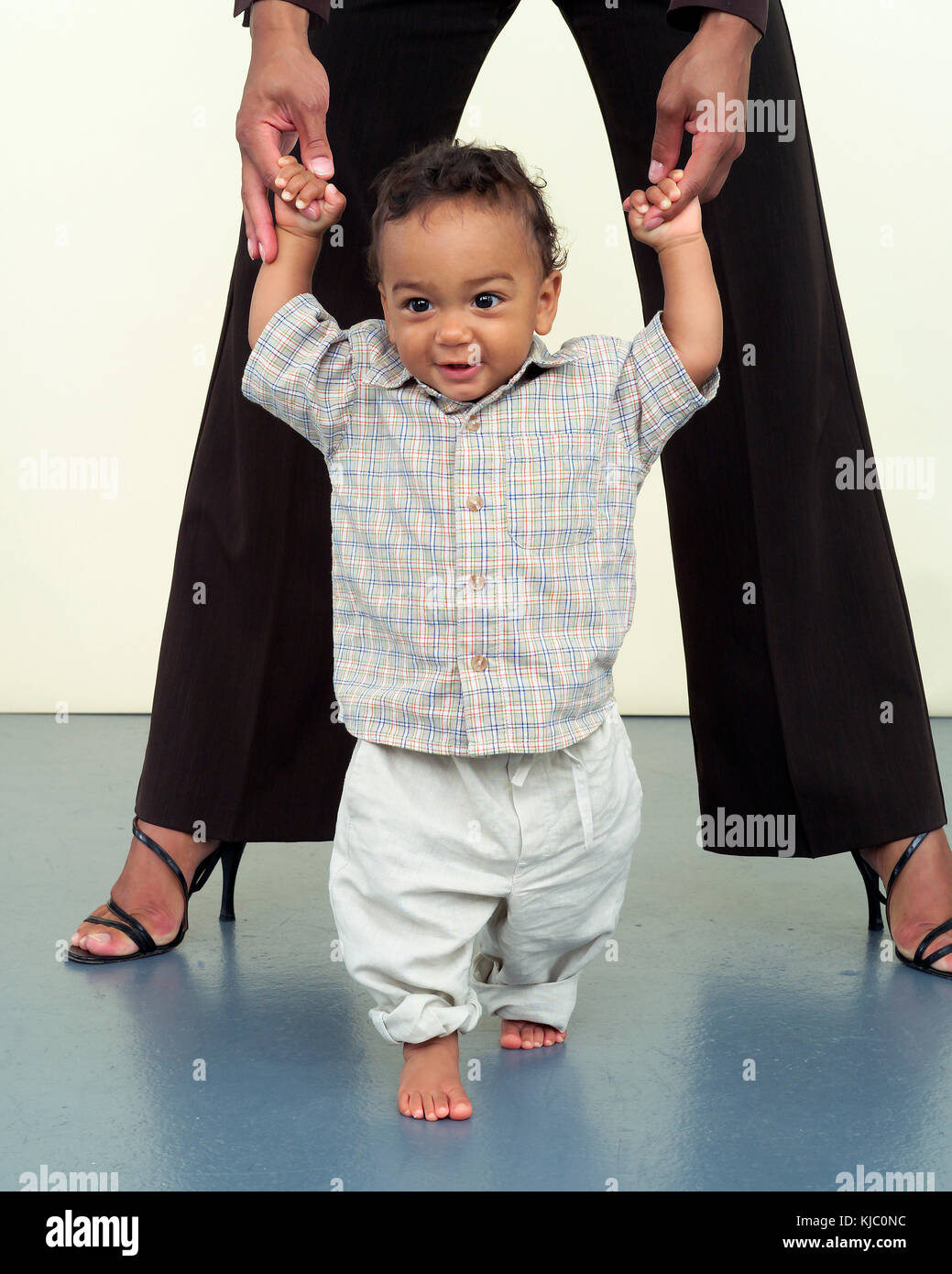 Child learning to walk stock photo alamy