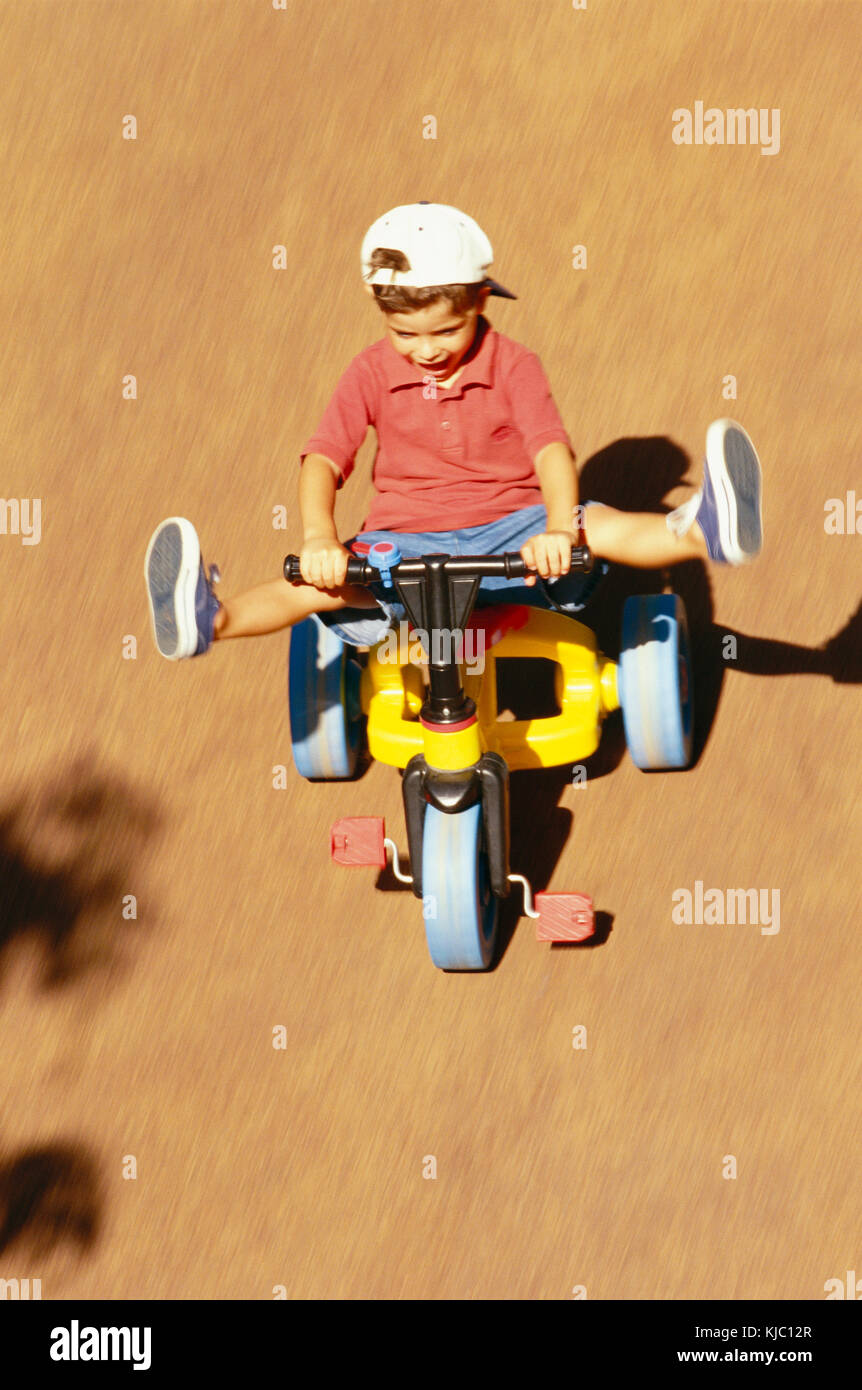 Boy Riding Tricycle Stock Photo Alamy
