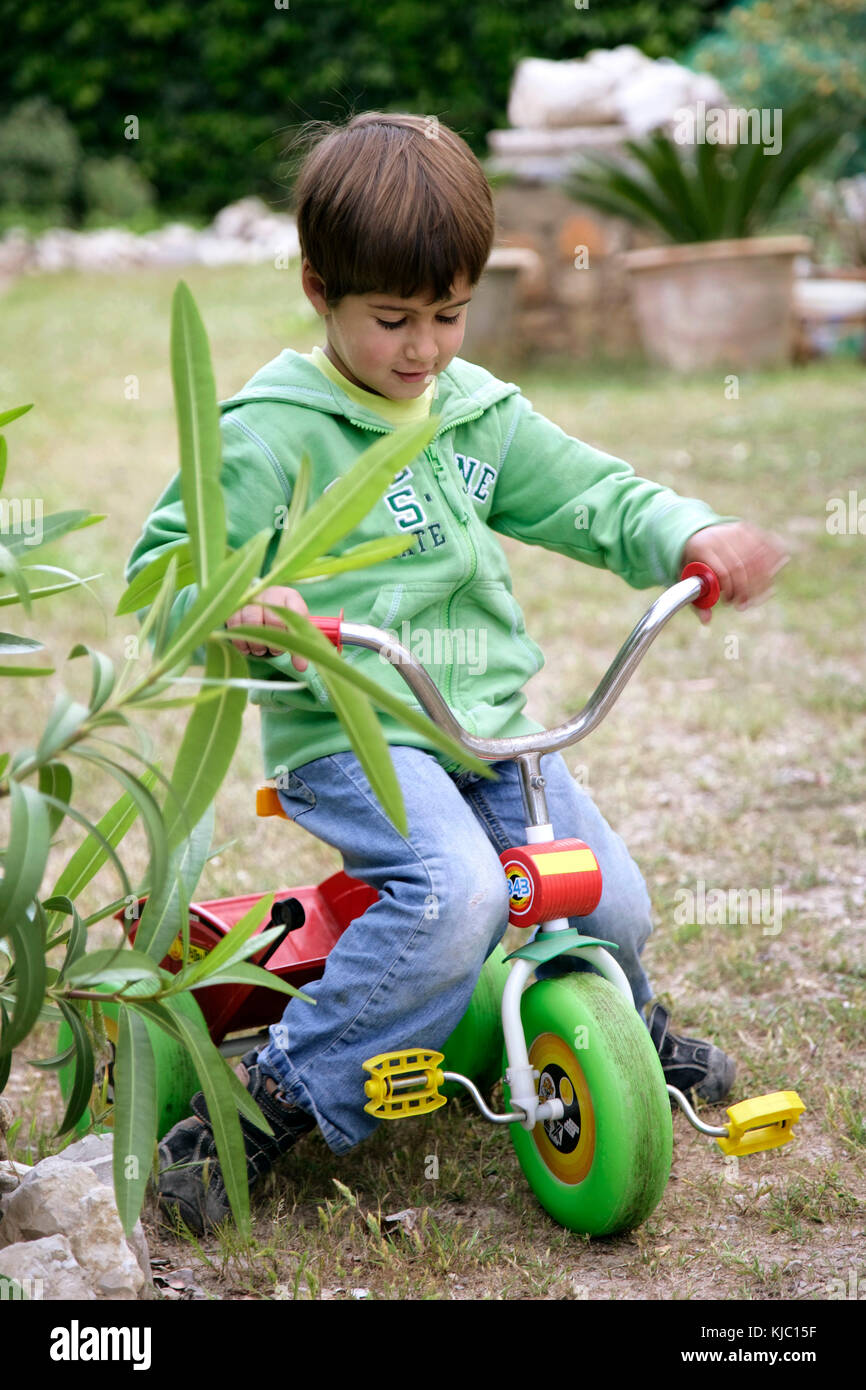 Boy Riding Tricycle Stock Photo Alamy