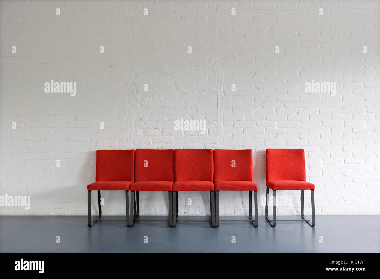 Red Chairs against Wall Stock Photo Alamy