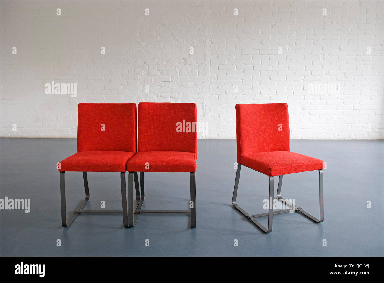 Red Chairs against Wall Stock Photo Alamy