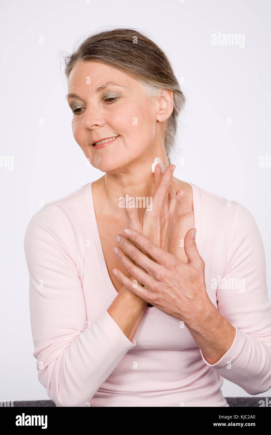 Woman Applying Lotion to Neck Stock Photo Alamy