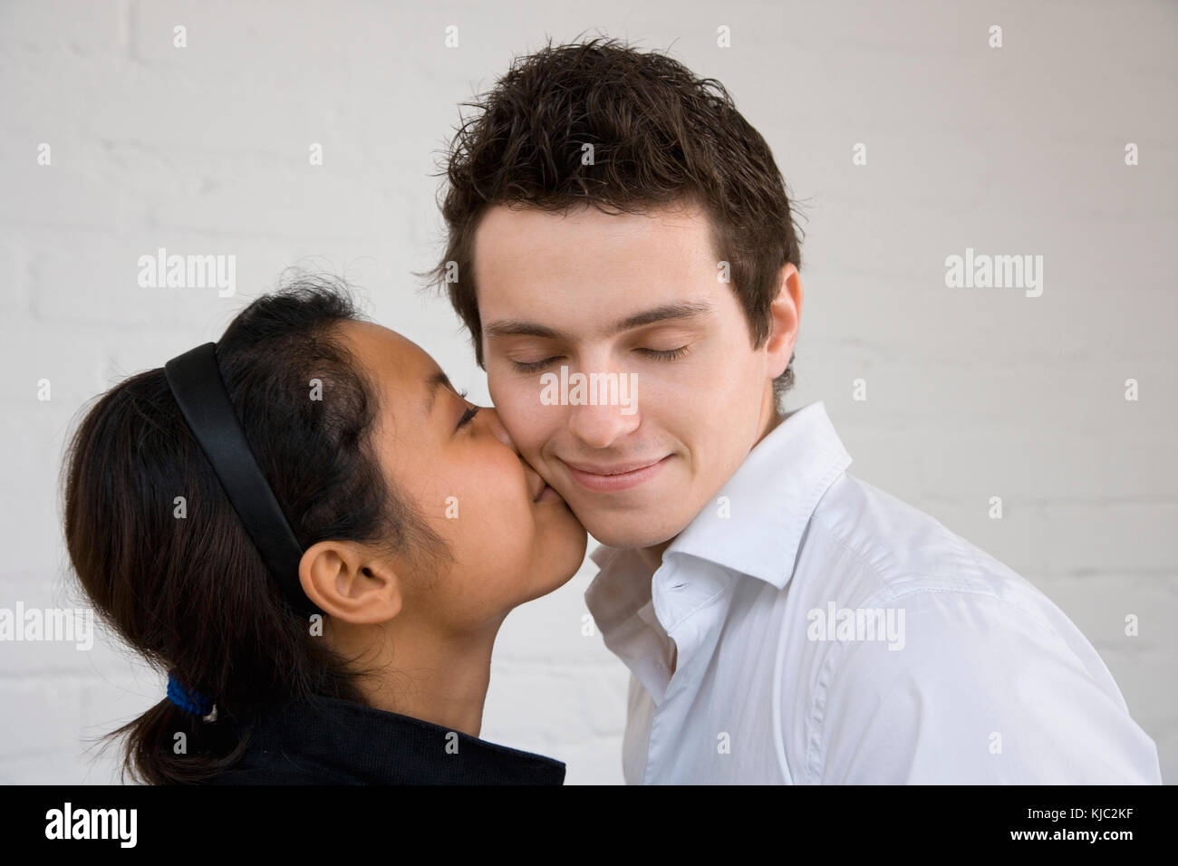 Woman Kissing Man On Cheek Stock Photo Alamy