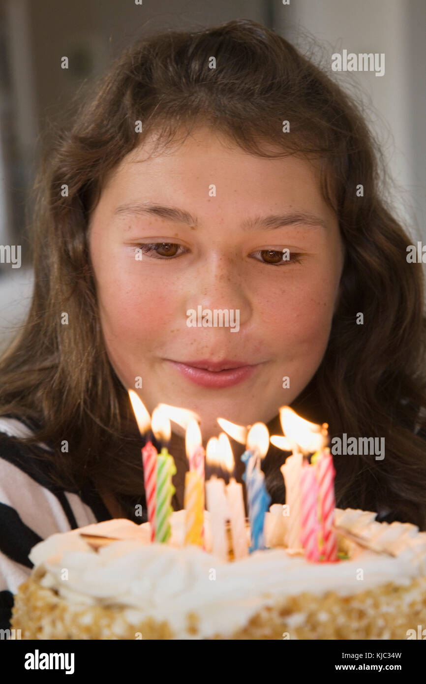 Girl Blowing Out Candles on Birthday Cake Stock Photo Alamy