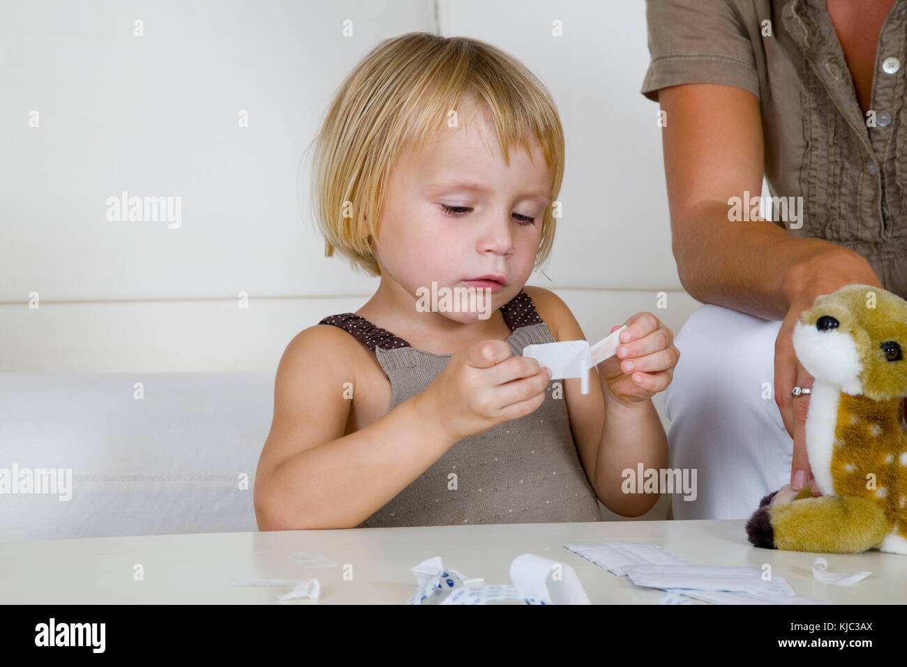 Little Girl Putting Bandaids on Stuffed Animal Stock Photo Alamy