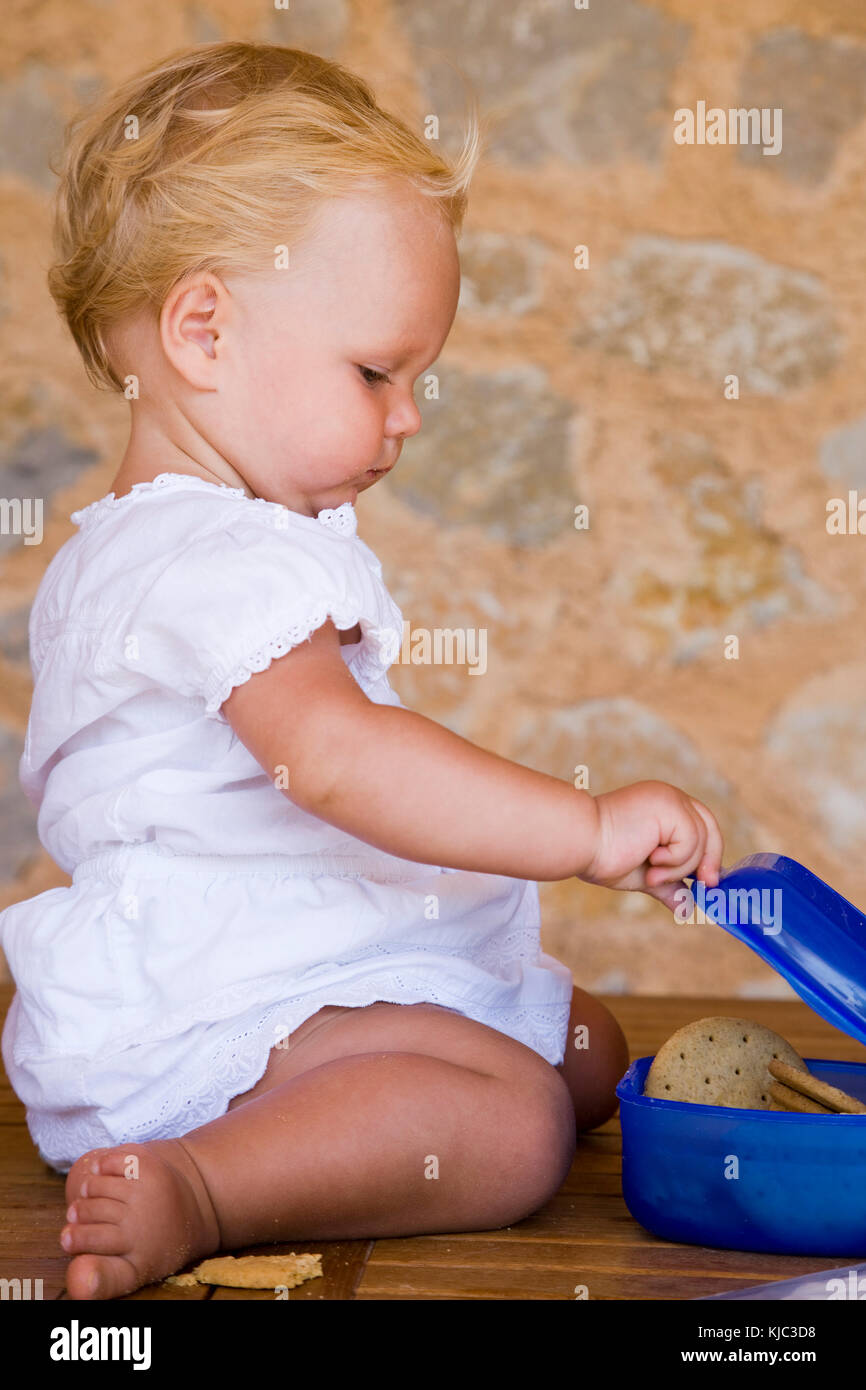 Child Opening Container with Cookies Inside Stock Photo - Alamy