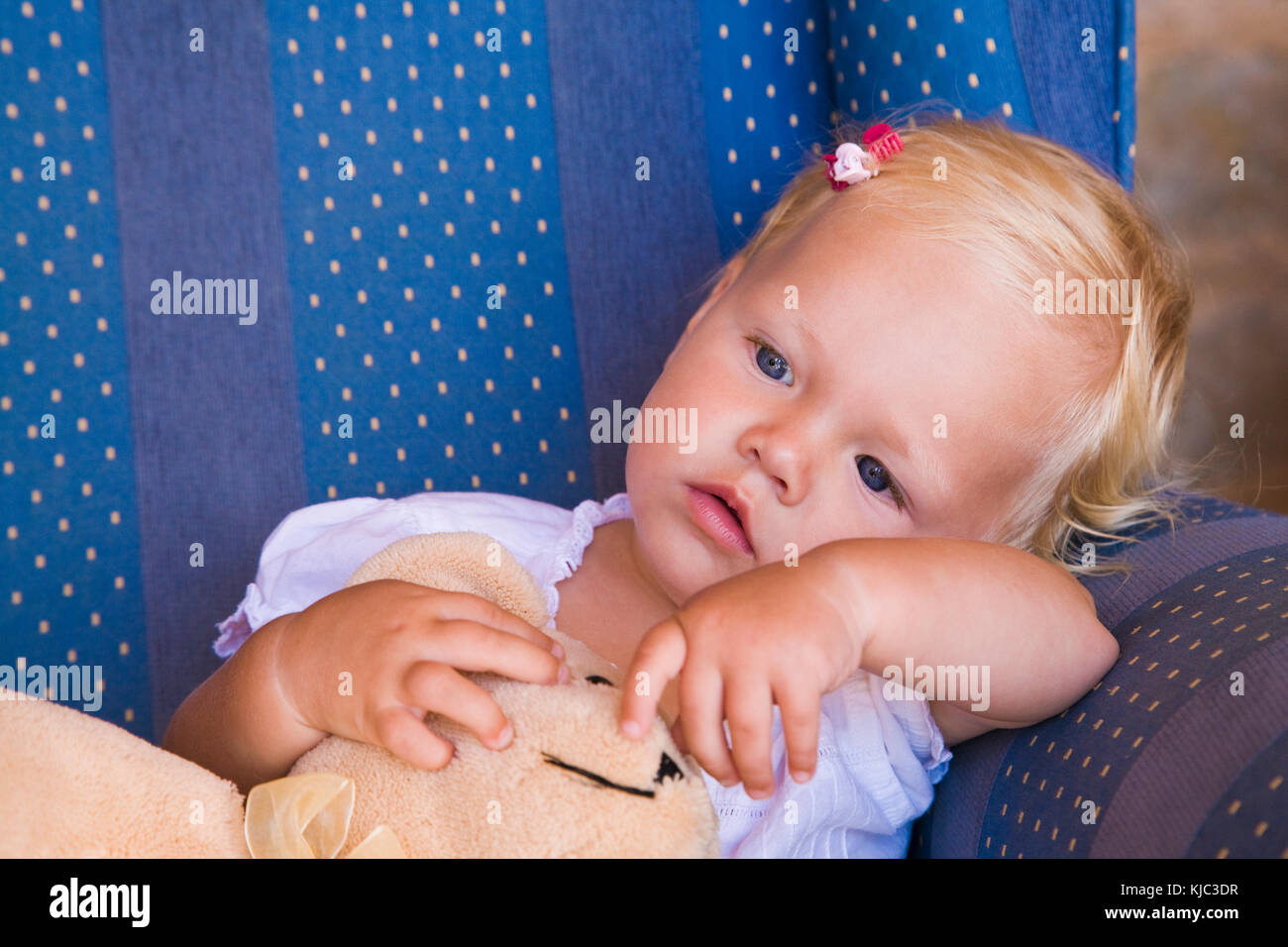 Toddler with Teddy Bear in Armchair Stock Photo - Alamy