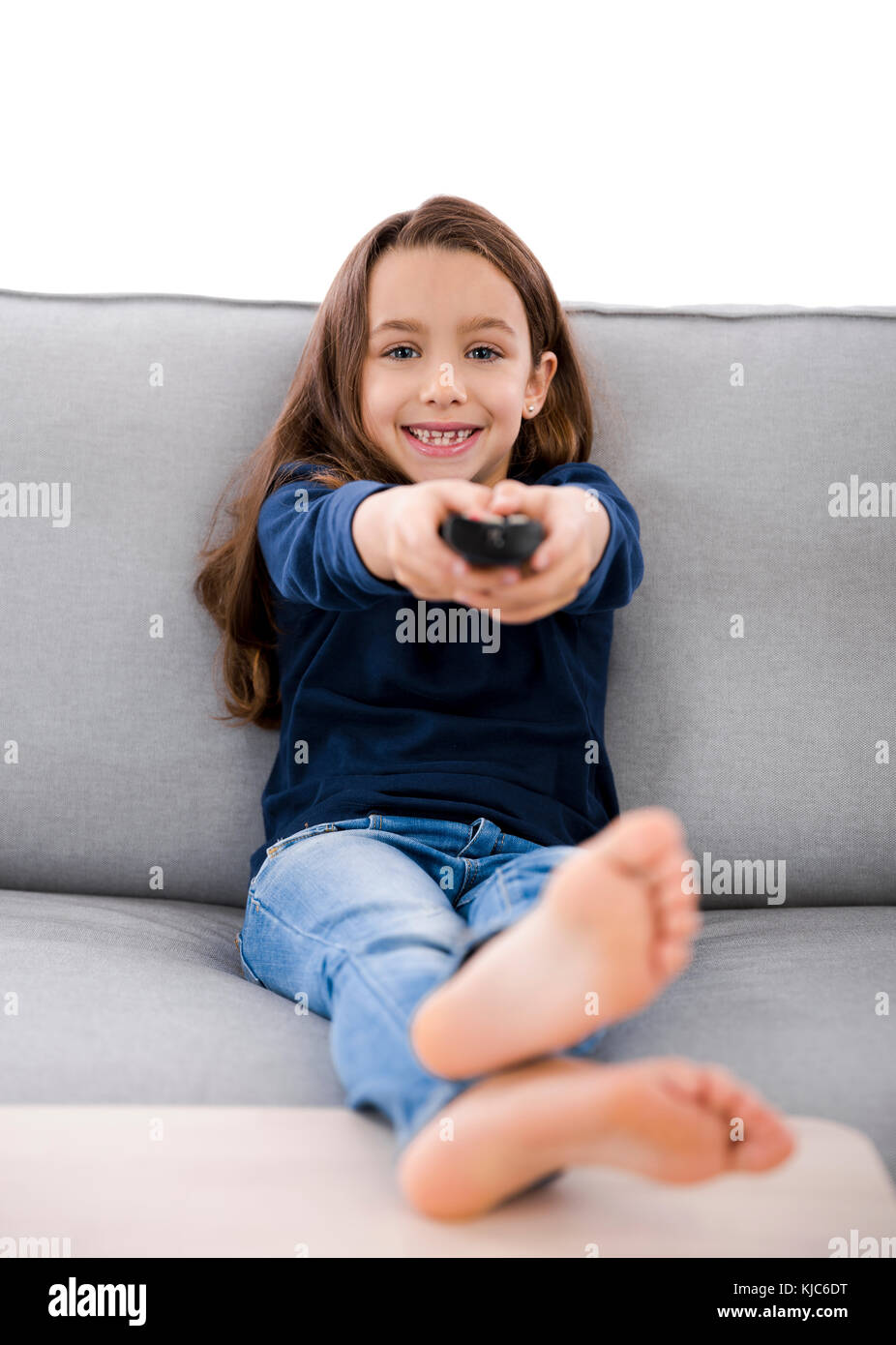 Little girl holding a TV remote control Stock Photo