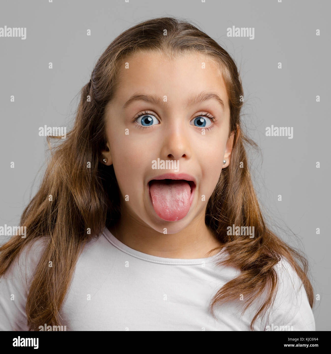 Portrait of a little girl with her tongue out Stock Photo