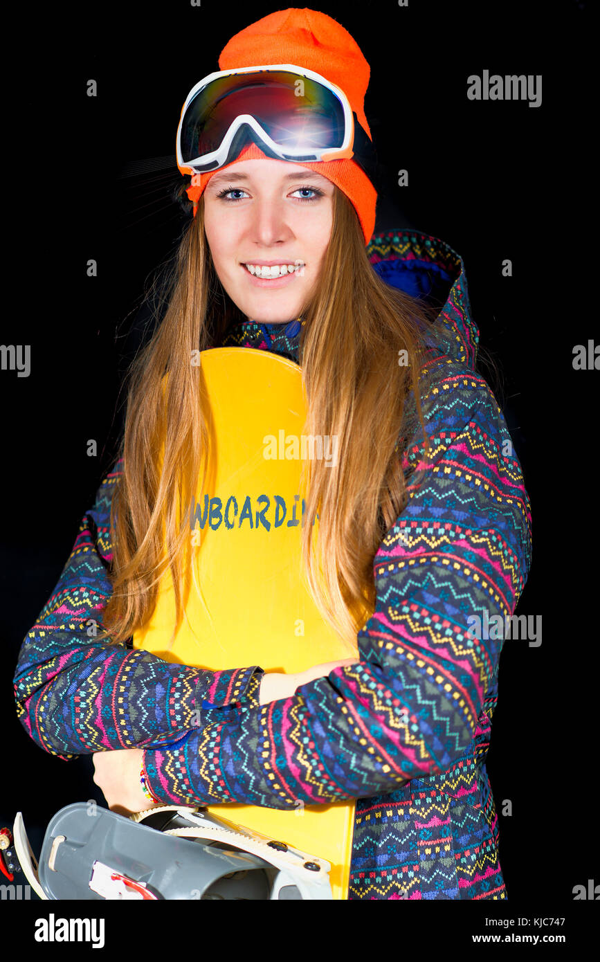 blond girl with long hair with snowboard and winter sportswear in