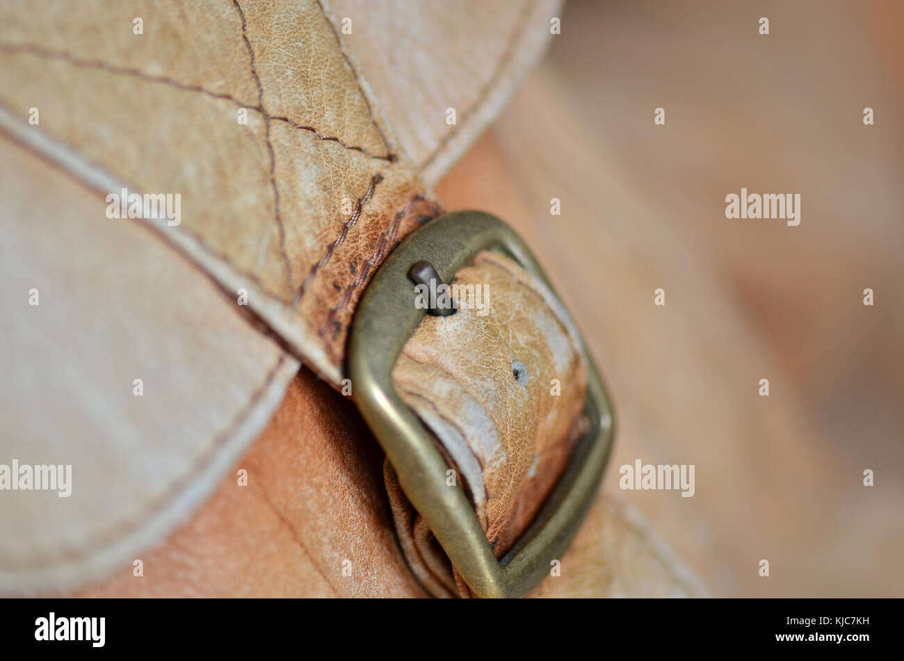 Close-up of a tan leather bag buckle fastening Stock Photo