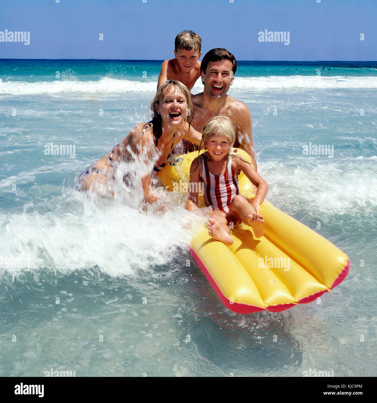 Family hon holiday aving fun in the sea! Stock Photo