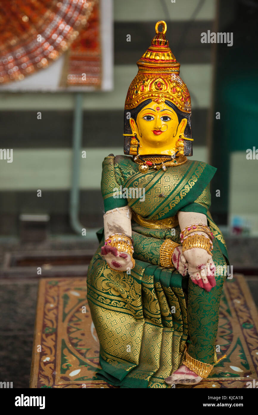 A religious Buddhist statue figure sits in a shop window in Charminar