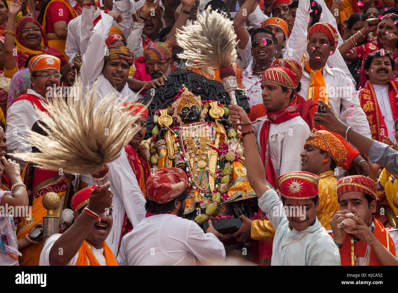 A Black stone image of Vishnu as Jagannath, Loard of the Universe is carried down the steps of the Jagdish Temple during a festival in Udaipur, India. Stock Photo