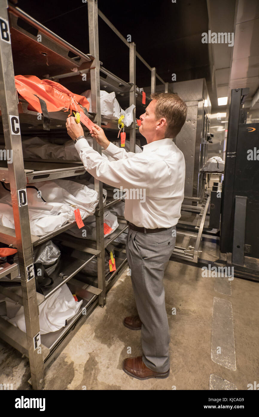 Tucson, Arizona - Dr. Gregory Hess, chief medical examiner for Pima County, checks the tag on an unidentified corpse in the morgue. The body is most l Stock Photo