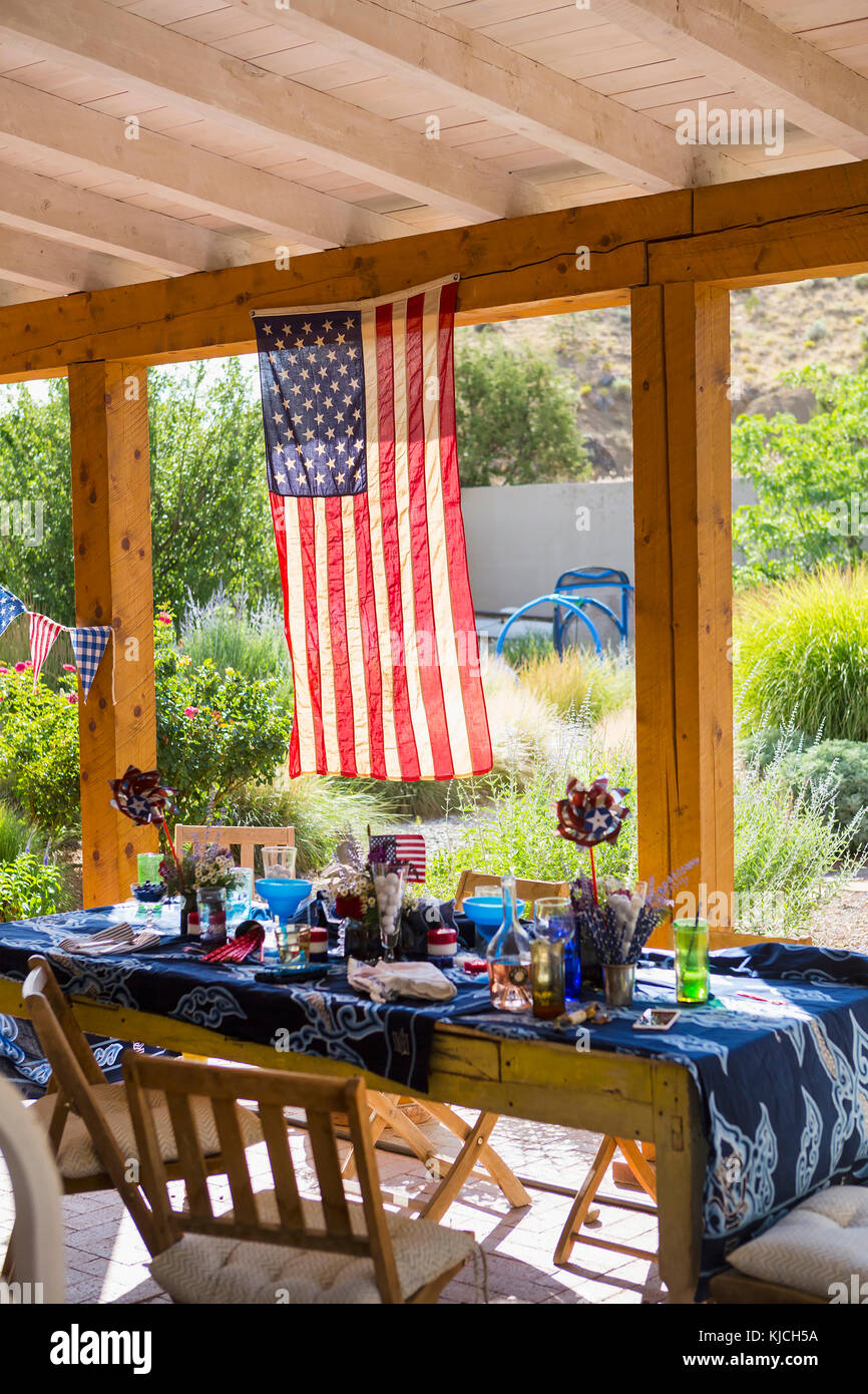 American flag hanging on patio near table Stock Photo