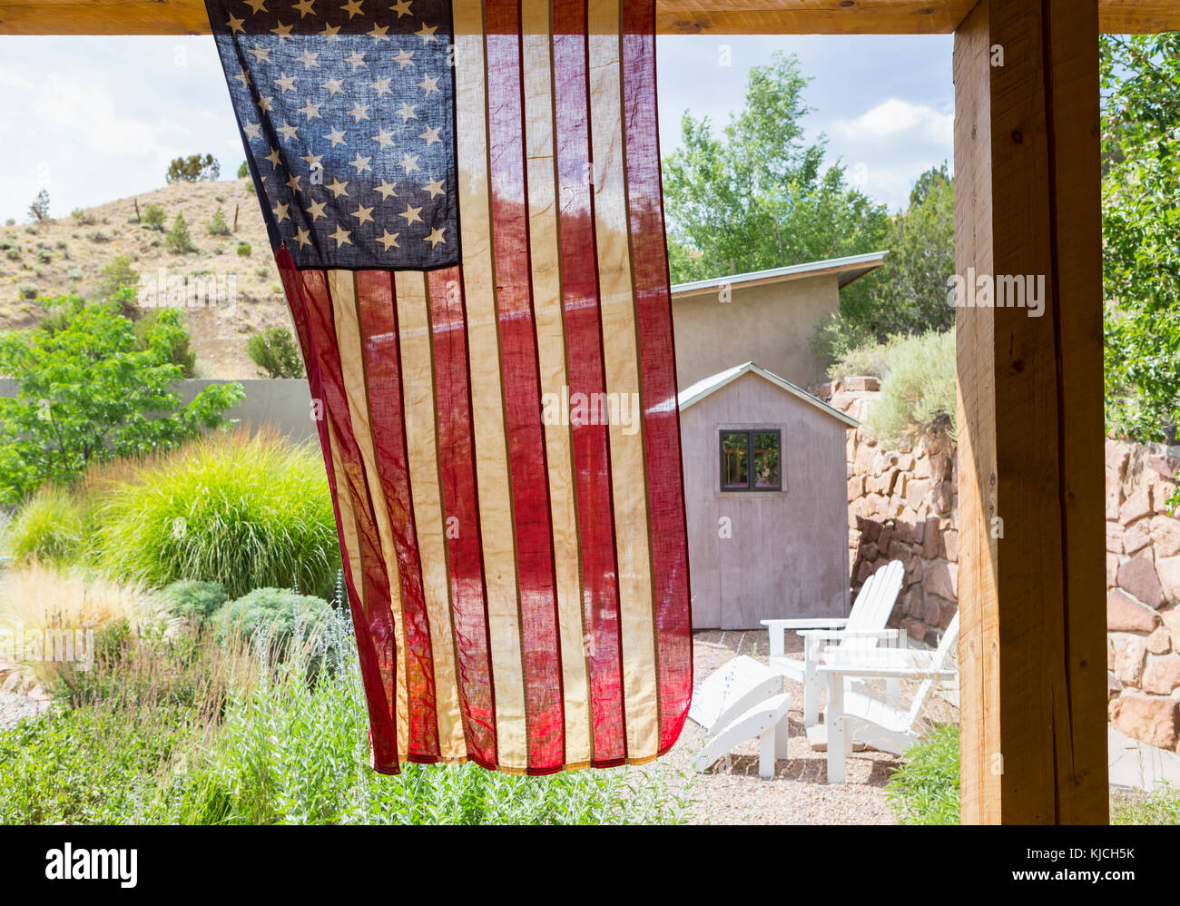 American flag hanging in backyard Stock Photo