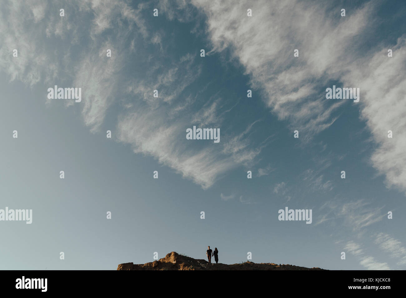 Distant Middle Eastern couple under cloudy sky Stock Photo - Alamy