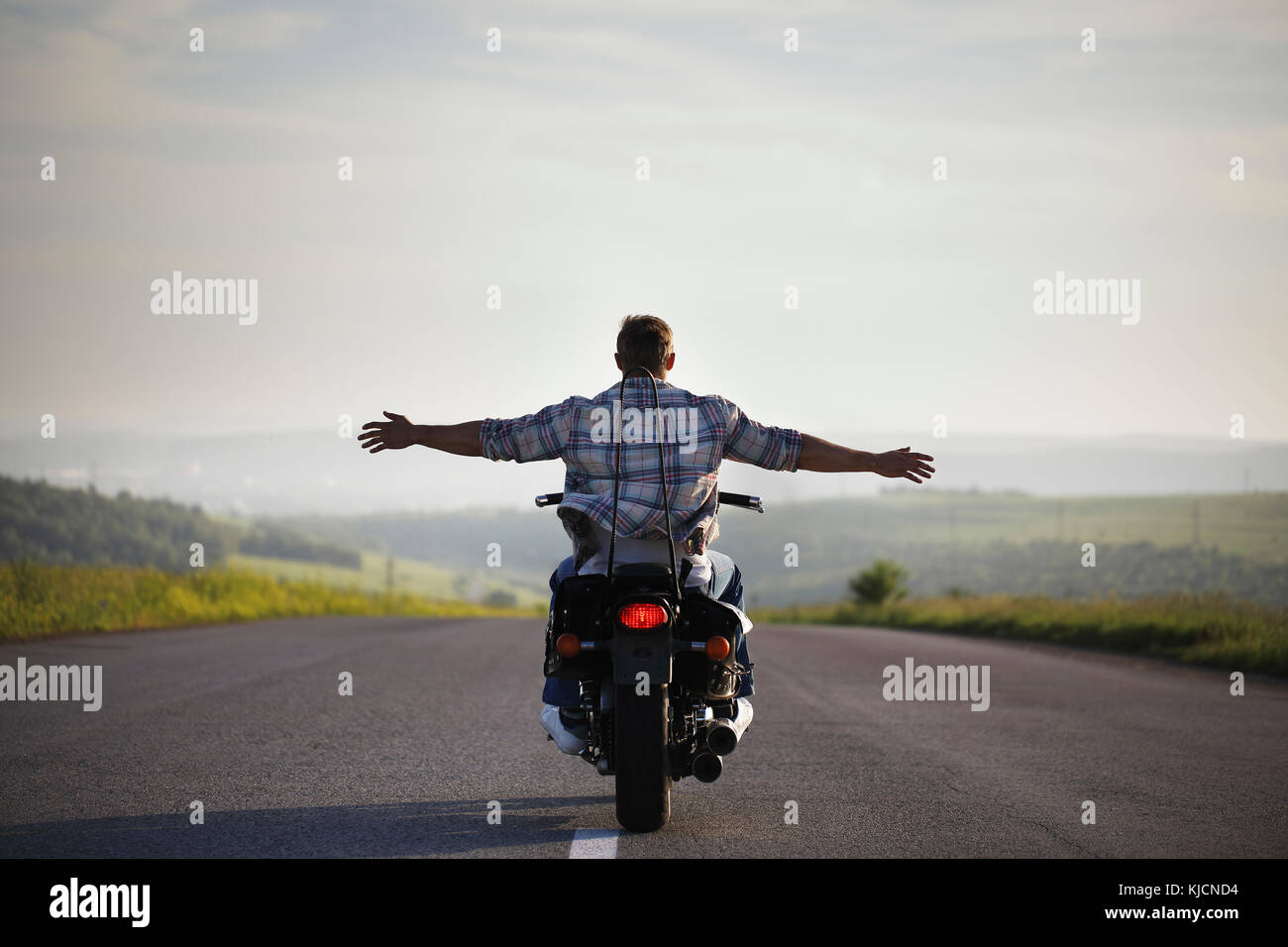 Caucasian man riding motorcycle with arms outstretched Stock Photo - Alamy