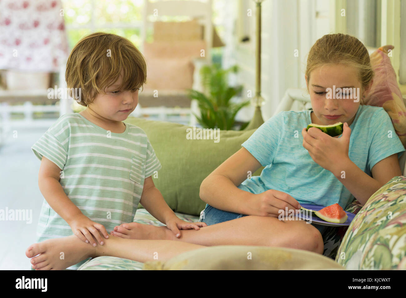 Caucasian brother and sister watching digital tablet on sofa Stock ...