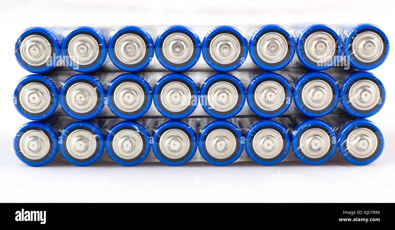 Lots of blue batteries, type AA, Packed in polyethylene film, on a white background, macro Stock Photo