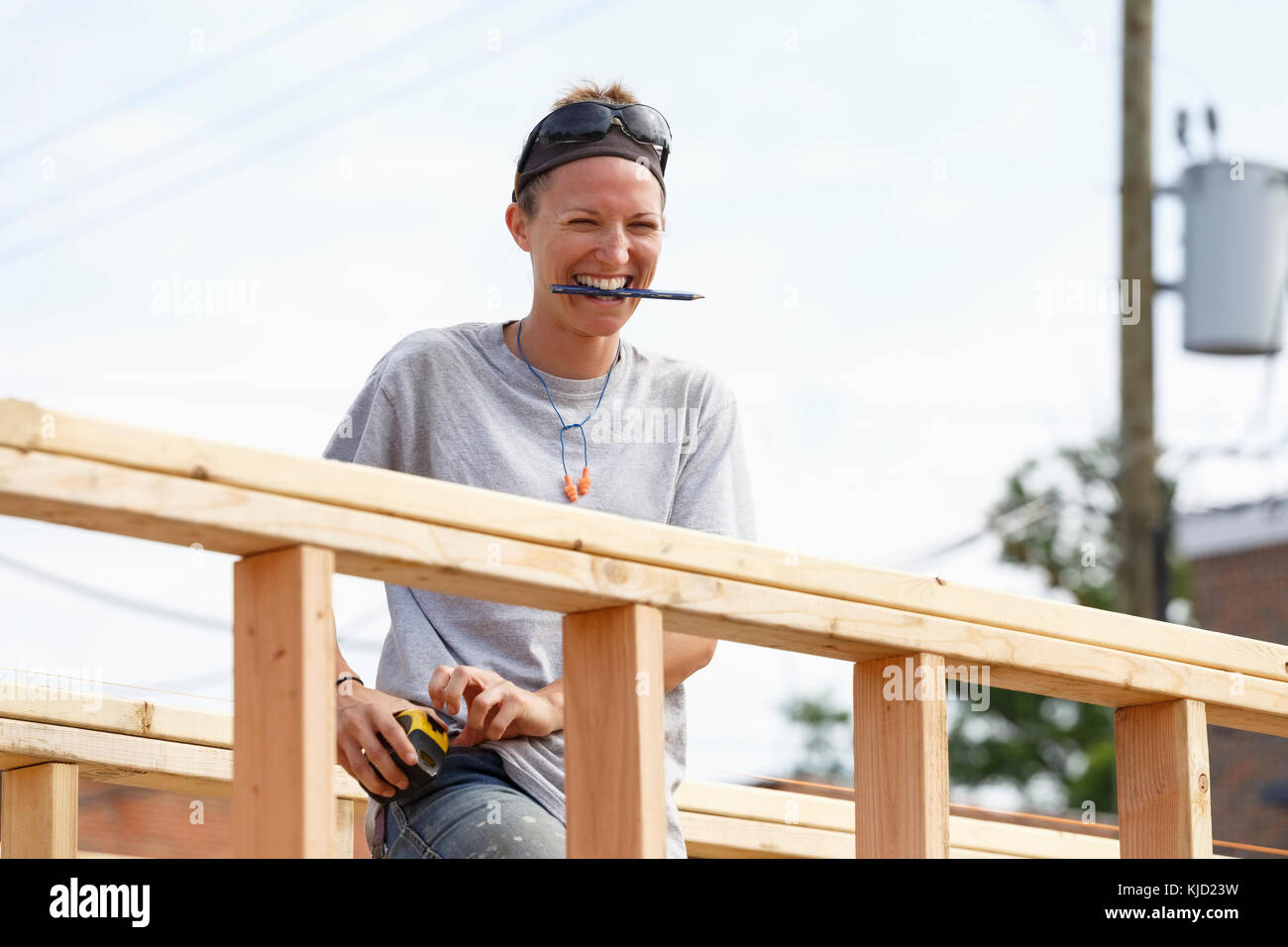 Caucasian woman laughing at construction site Stock Photo