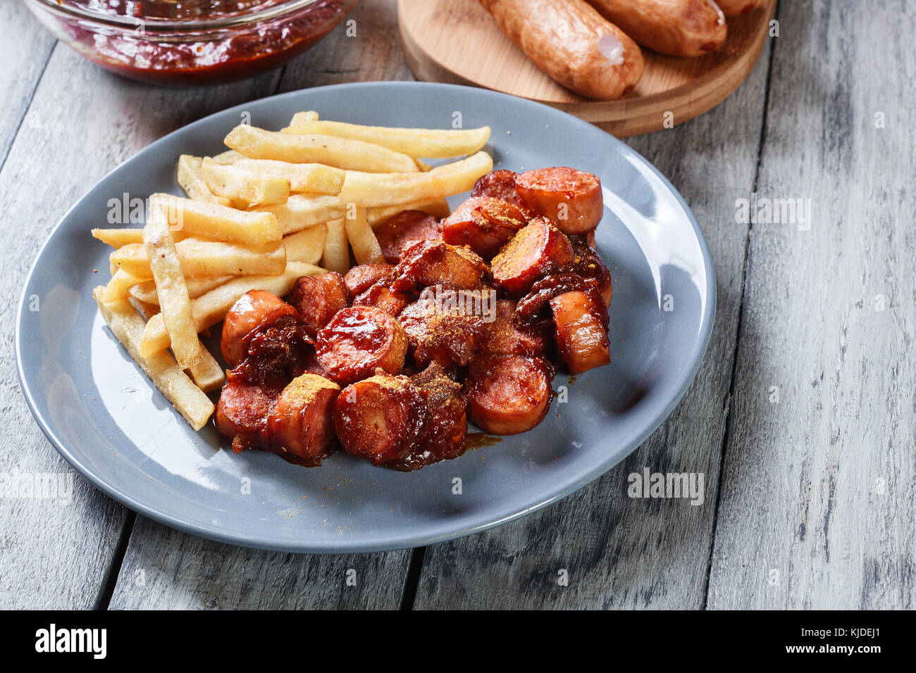 Traditional German currywurst - pieces of sausage with curry sauce and  french fries Stock Photo - Alamy