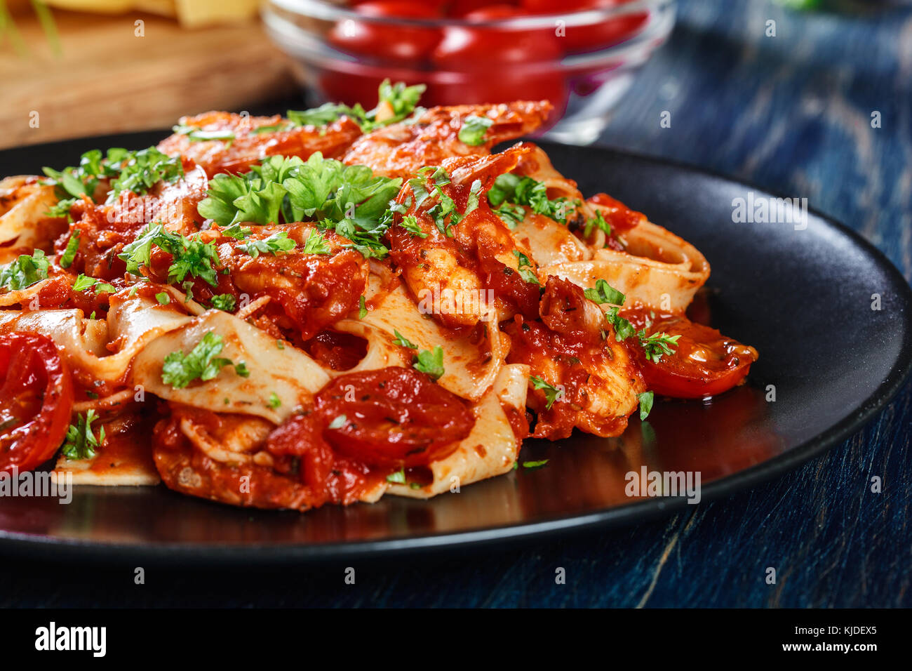 Pappardelle pasta with shrimp, tomatoes and herbs. Italian cuisine