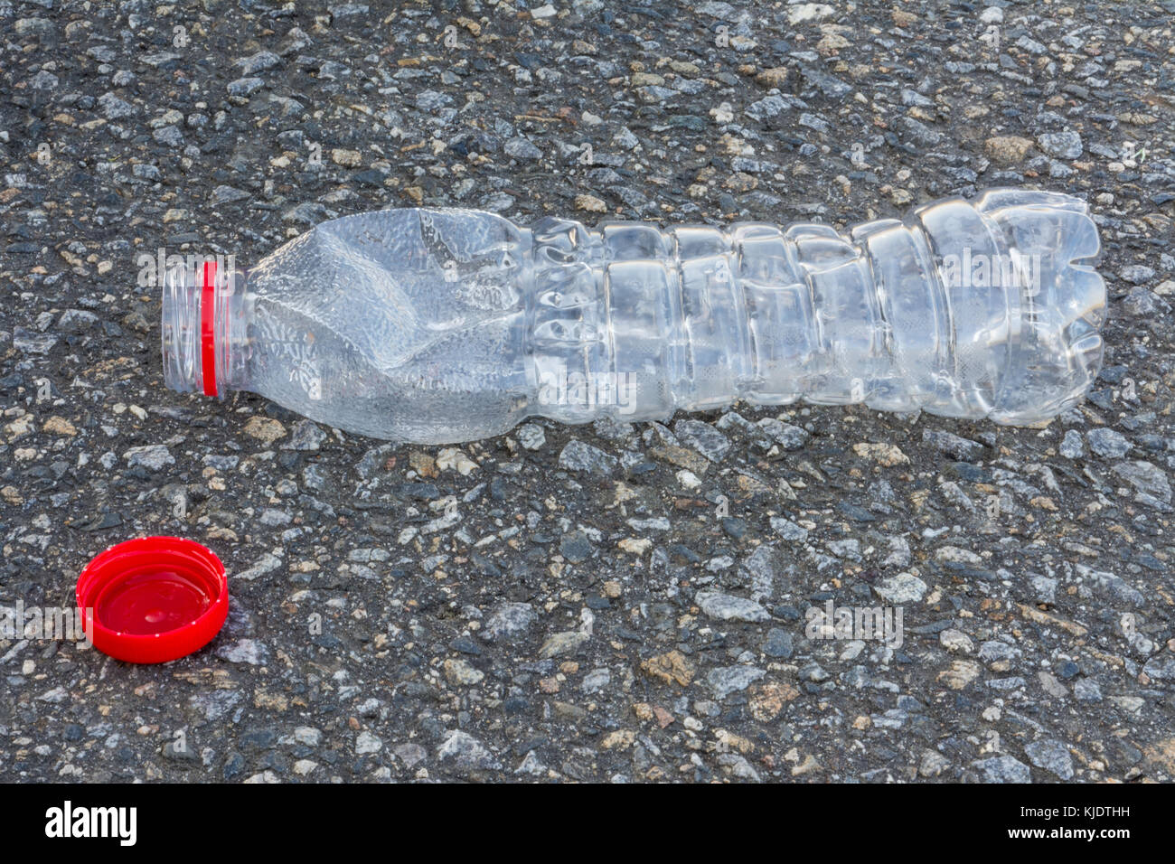 Plastic bottle with red cap. Ecological disposal of plastic waste. Transparent pet bottle on