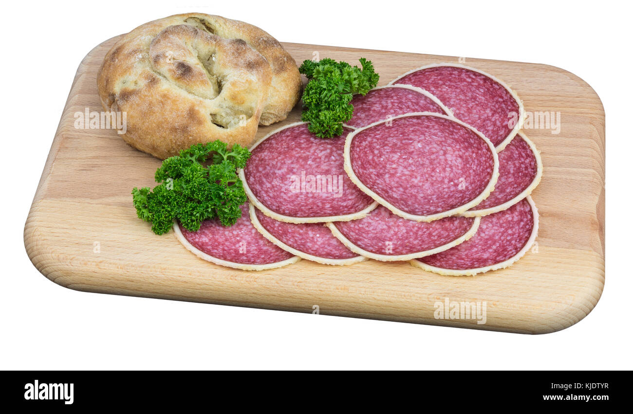 Hearty snack on cutting board. Spicy salami and olive bread with parsley garnish. Isolated on white background. Stock Photo