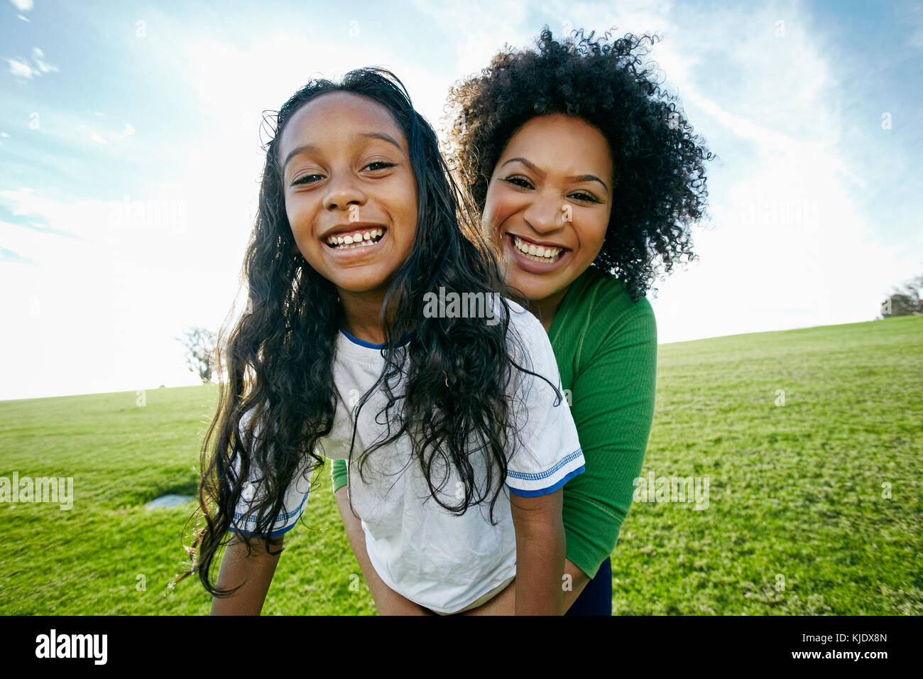 Portrait of smiling mixed raced mother and daughter Stock Photo