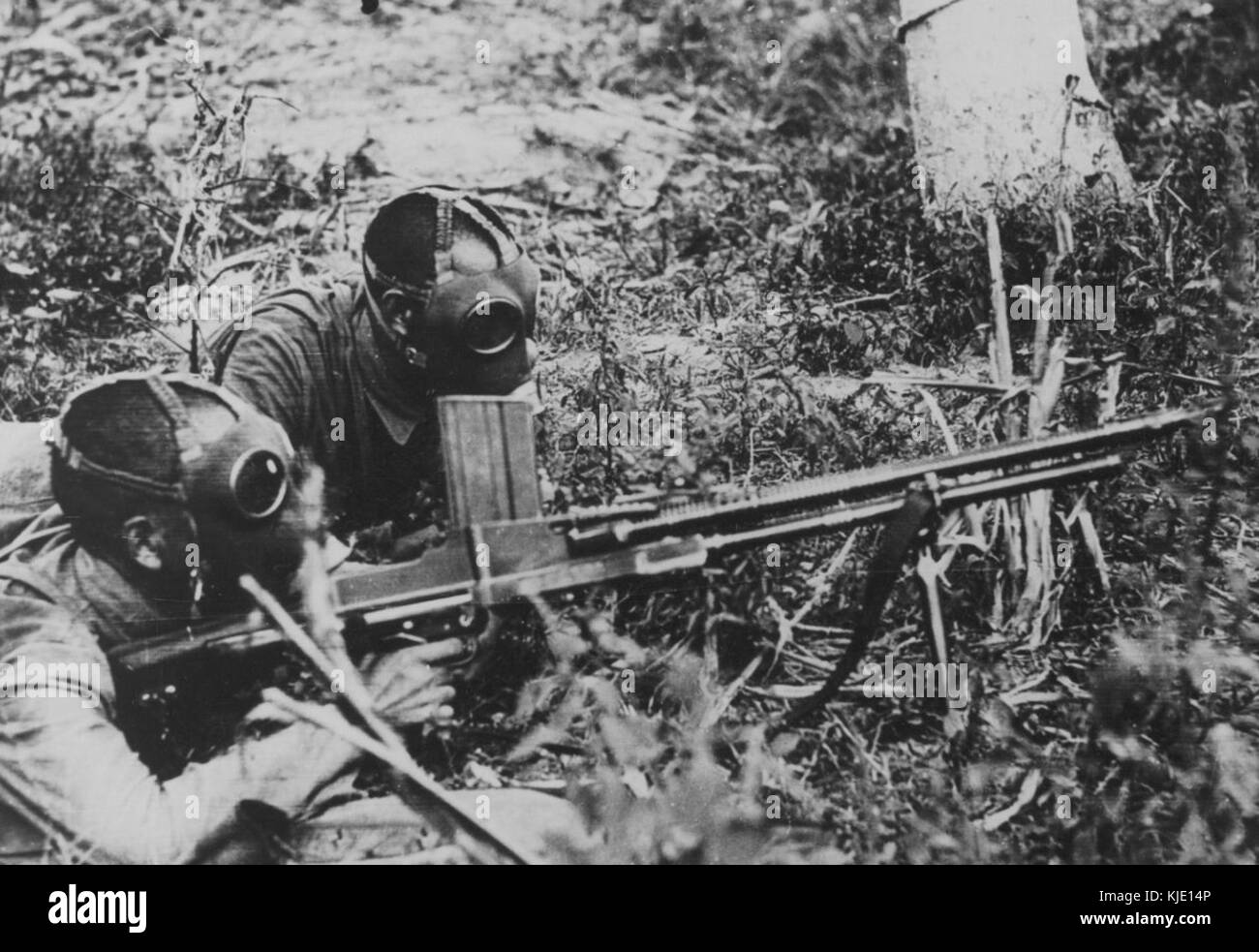 Chinese soldiers wearing gas masks and armed with a Czech ZB vz. 26 light machine gun Stock Photo