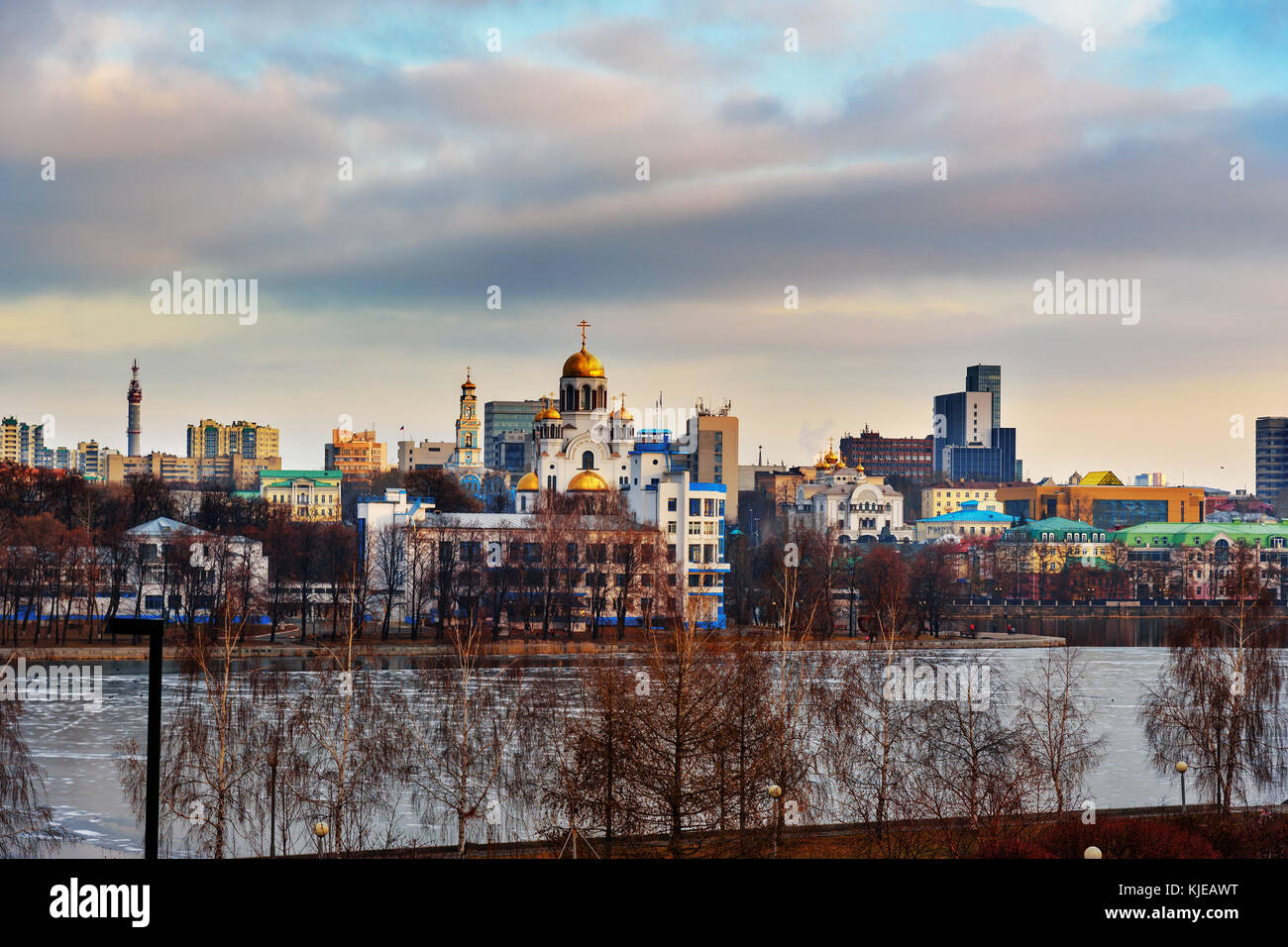 View of Iset river embankment on sunset. With Church on Blood in Honour of All Saints. Yekaterinburg. Russia Stock Photo