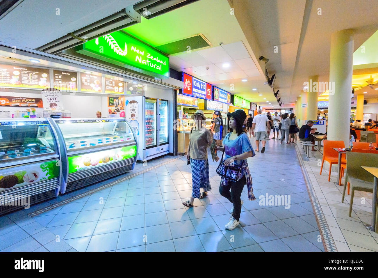 Two young Chinese women walking through a food court, Cairns, Far North Queensland, FNQ, QLD, Australia Stock Photo