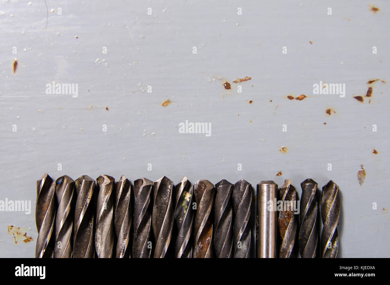 a lot of drills of different sizes on a painted metal background. concept of a different way of life. Stock Photo