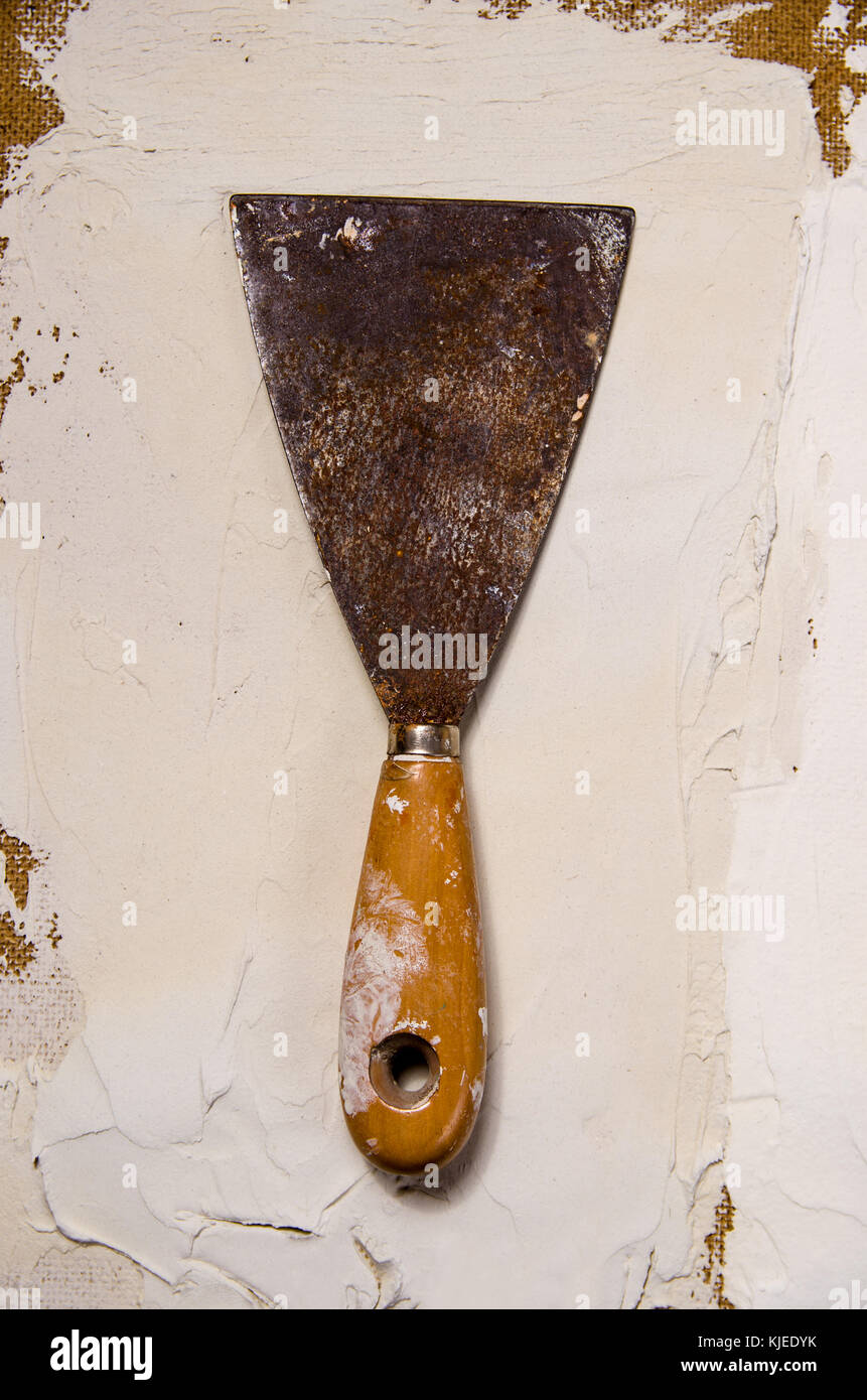 a vintage putty knife on the background of putty Stock Photo