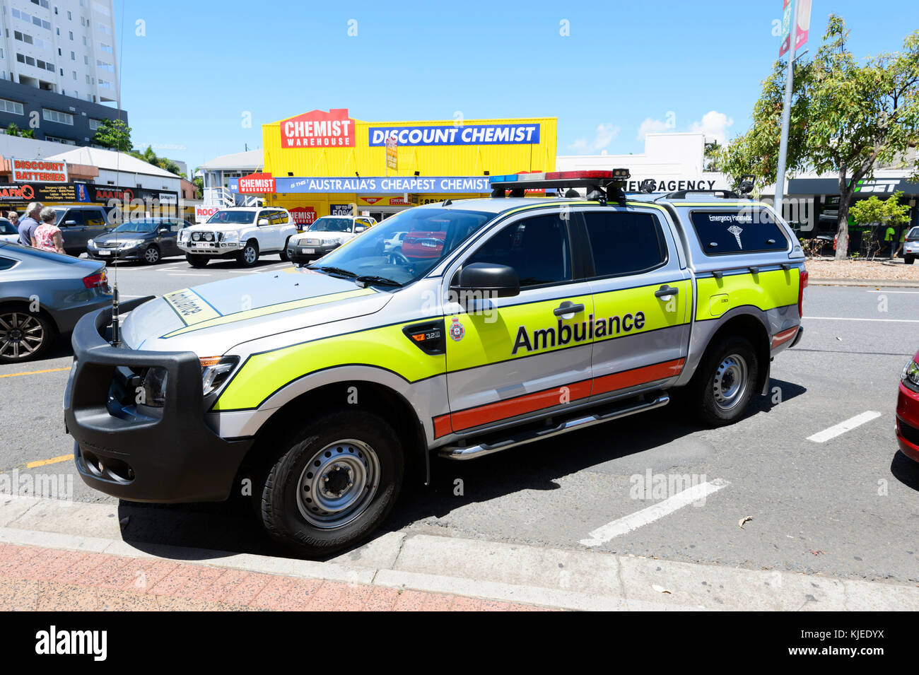 Ambulance parked opposite a Discount Chemist store, Cairns, Far North Queensland, FNQ, QLD, Australia Stock Photo