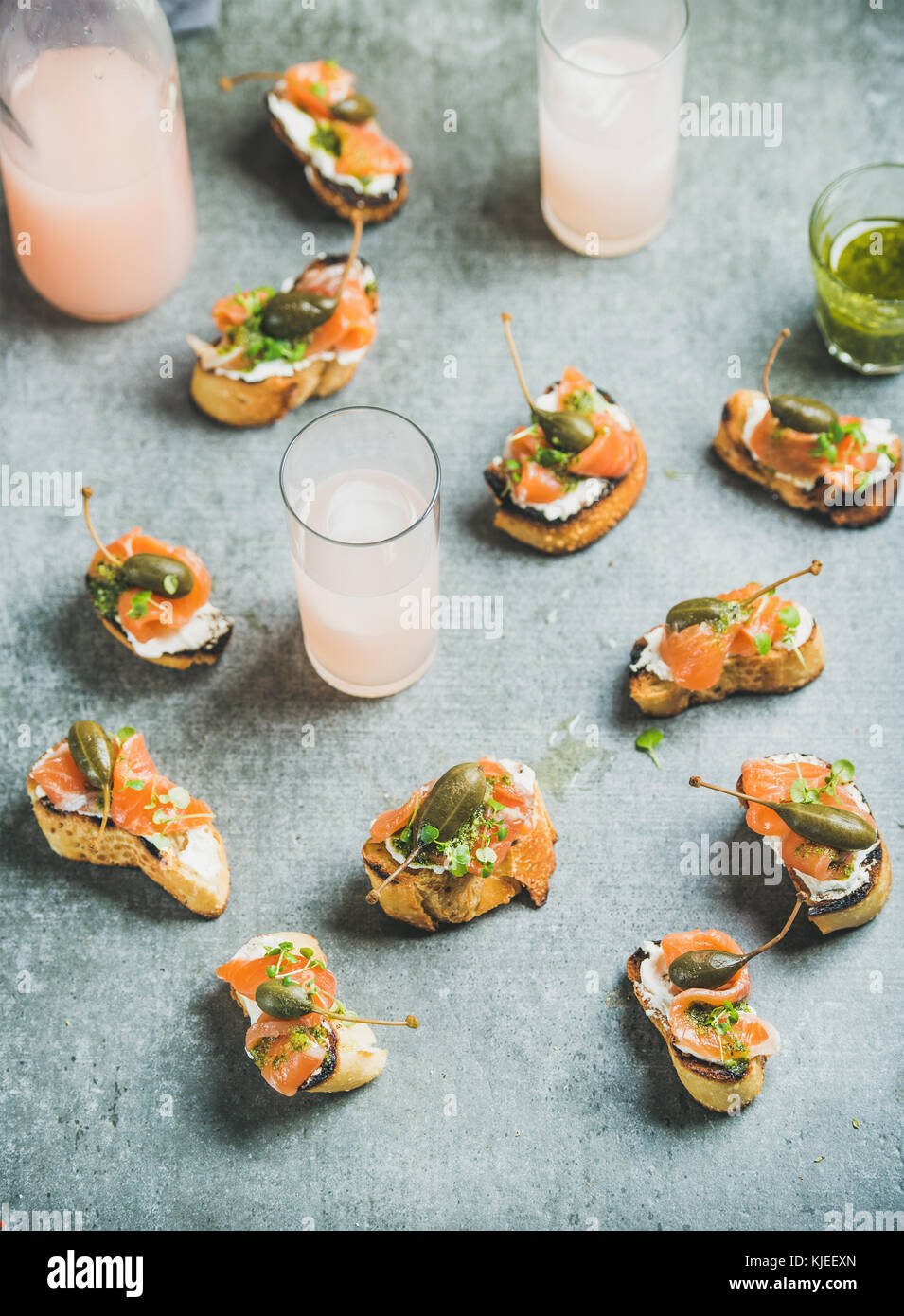 Crostini with smoked salmon and grapefruit cocktails in glasses Stock