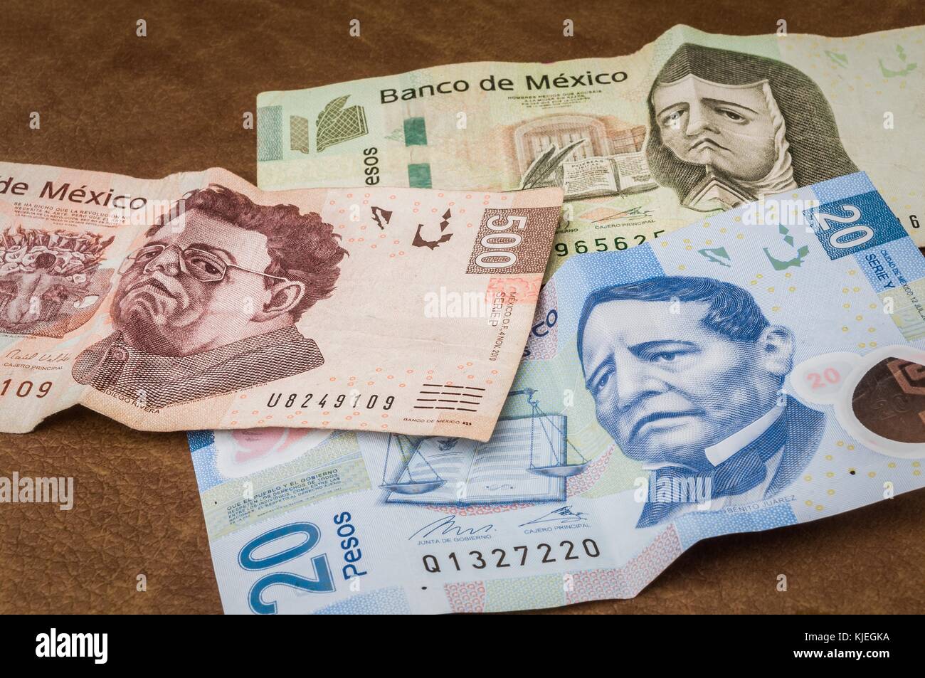 Some bills of 20, 200 and 500 mexican pesos seems to be sad. Stock Photo