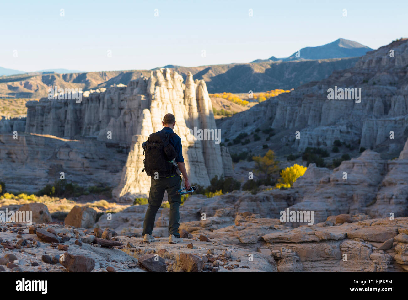 Caucasian man carrying backpack in desert Stock Photo