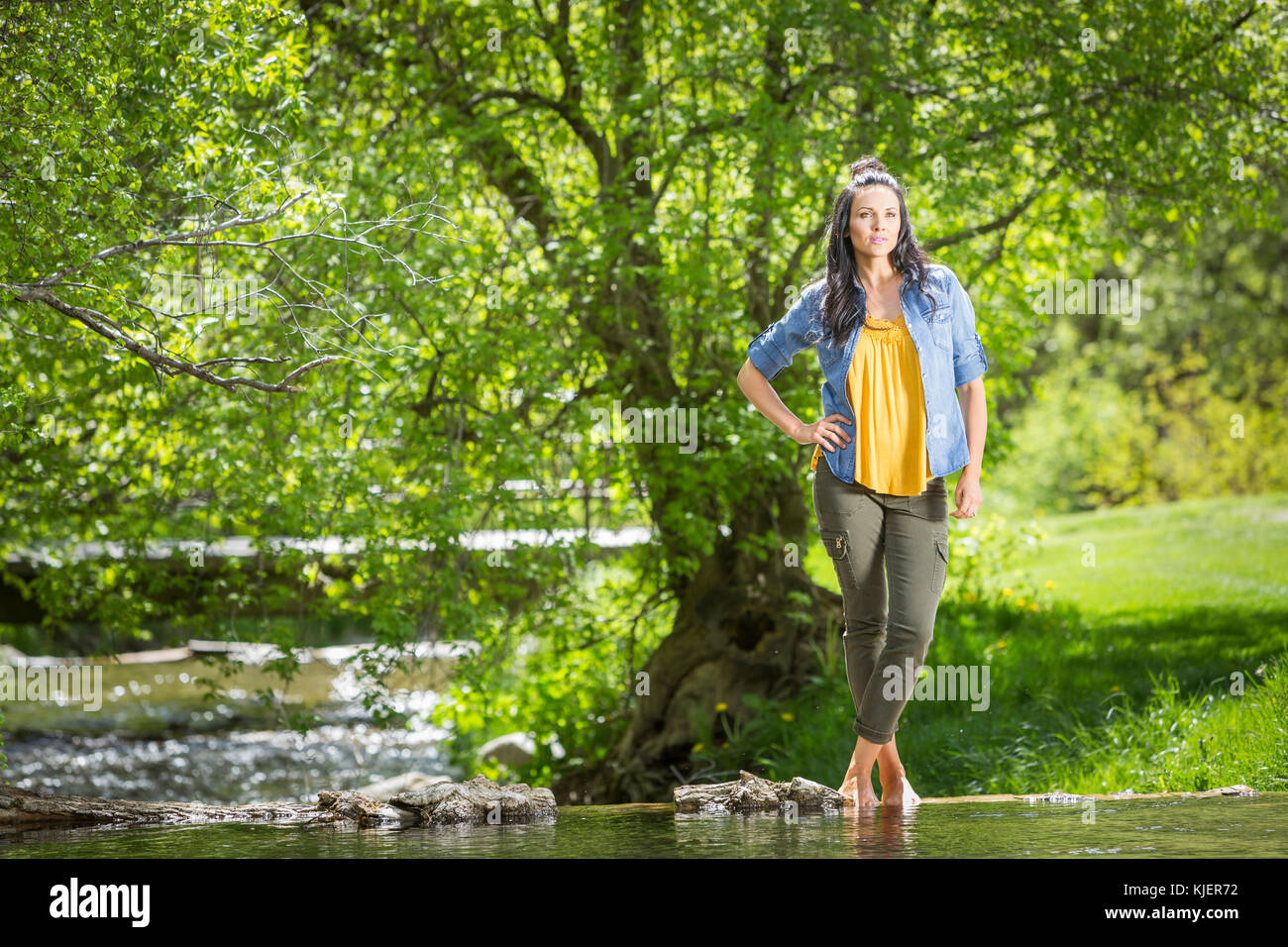 Coffin Caucasian woman standing near river Stock Photo - Alamy