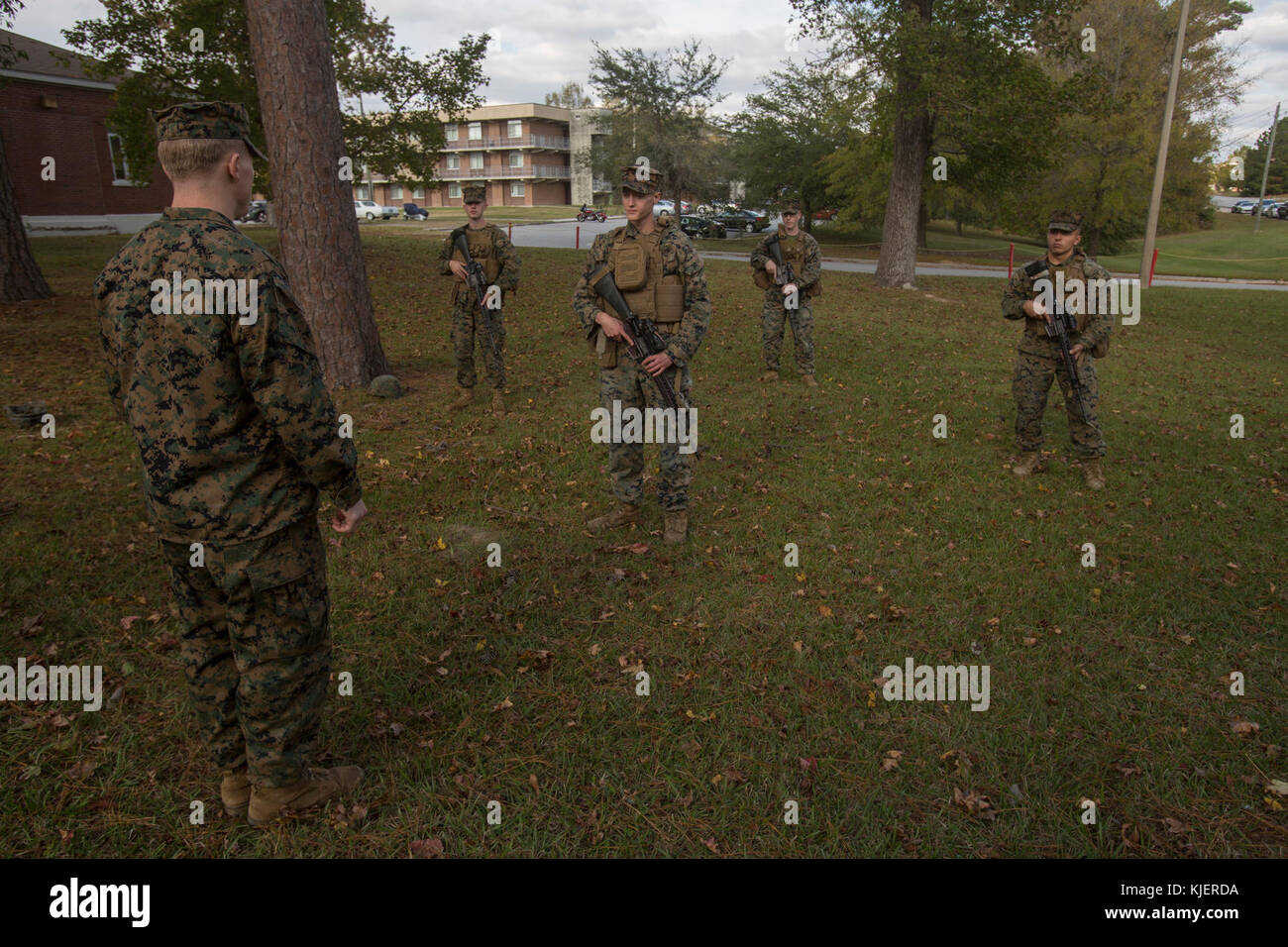 Sgt. Timothy Buntting, an infantry squad leader with 3rd Battalion, 8th Marine Regiment, tests the knowledge of hand & arm signals and patrolling formations of artillery Marines with 2nd Battalion, 10th Marine Regiment at Camp Lejeune, N.C., Nov. 14, 2017. The infantry Marines taught the artillerymen advanced patrolling tactics in preparation for their upcoming deployment. (U.S. Marine Corps photo by Lance Cpl. Ashley McLaughlin) Stock Photo