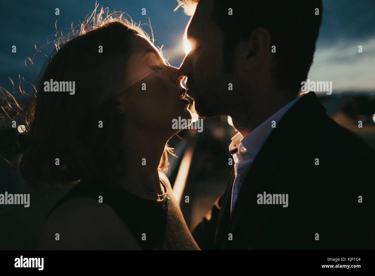Caucasian couple kissing at night Stock Photo Alamy
