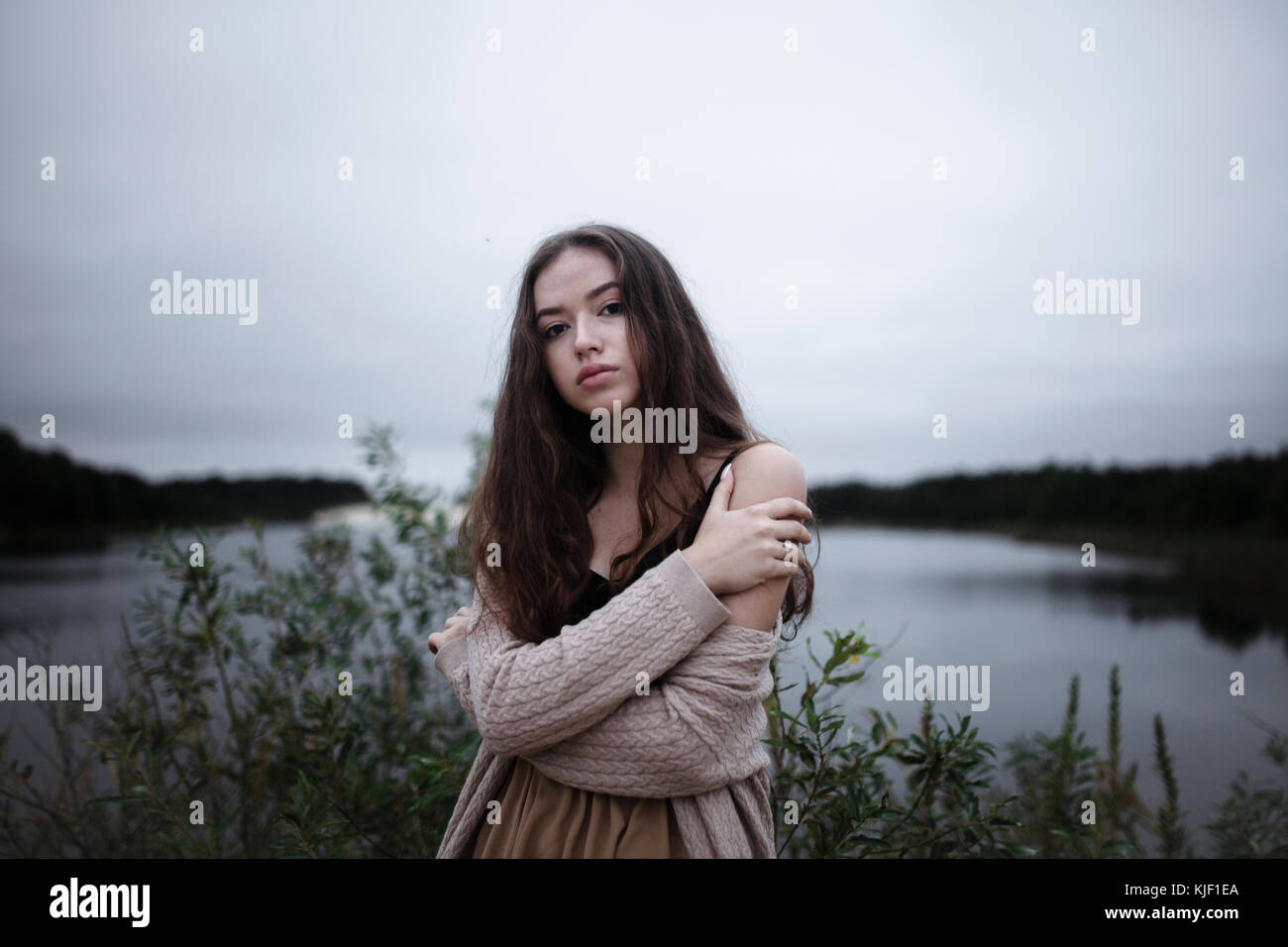 Portrait of serious Caucasian woman standing near a river Stock Photo ...