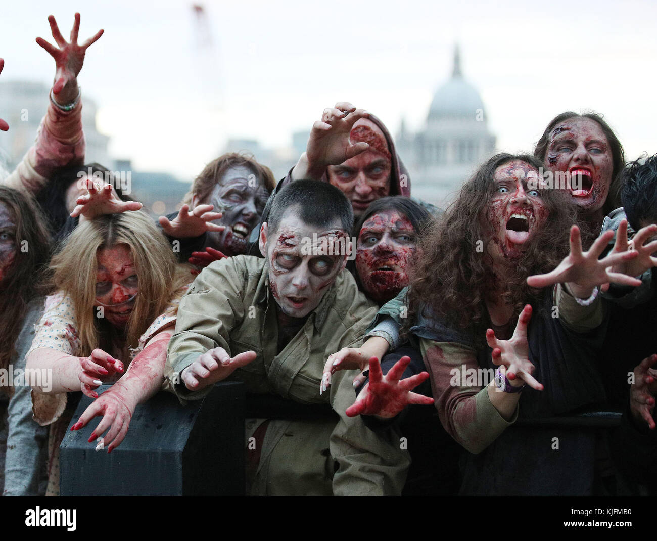 The Walking Dead descend on ‘Walkerloo’ - 100 ‘Walkers’ in gory prosthetics marked the 100th episode of the hit TV show The Walking Dead, which premieres on Fox tonight at 9pm. After eight hours in make-up, the 100 fanatics walked from the Southbank and over Waterloo Bridge before converging on the London underground, shocking commuters in their path.  Where: London, United Kingdom When: 23 Oct 2017 Credit: Joe Pepler/PinPep/WENN.com Stock Photo