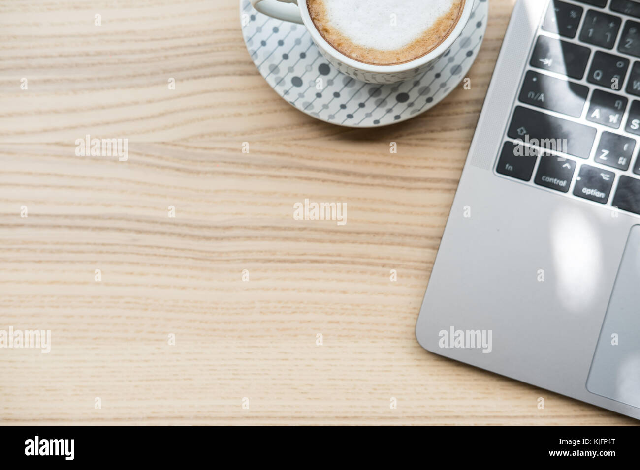 computer notebook, coffee cup on wood desk. laptop at office workplace ...
