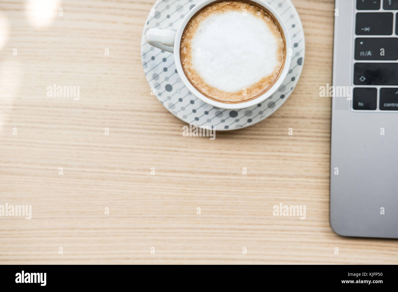 computer notebook, coffee cup on wood desk. laptop at office workplace ...
